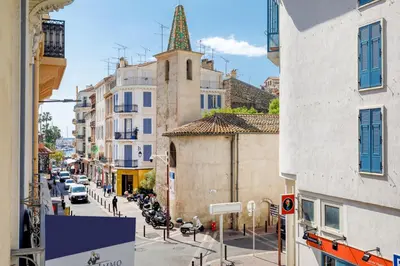 a city street with buildings and a clock tower at Gazagnaire YourHostHelper in Cannes