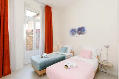 two beds with stuffed animals on them in a room at Gazagnaire YourHostHelper in Cannes
