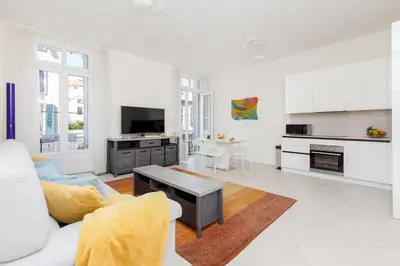a living room with a couch and a table at Gazagnaire YourHostHelper in Cannes