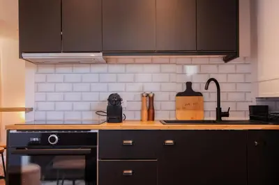 a kitchen with a stove and a counter top at Villa Corbelle - Grand Studio in Cannes