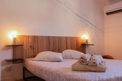 a bedroom with a large bed and a desk at Villa Corbelle - Grand Studio in Cannes