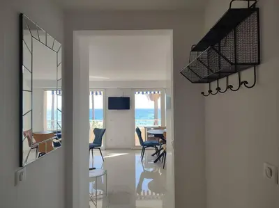 a hallway with a living room and a dining room at Le Madrigal by Halldis in Cannes