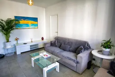 a living room with a couch and a table at Ref SELV -Palmes d'Or Properties in Cannes