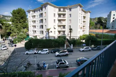 a parking lot with cars parked in front of a building at Ref SELV -Palmes d'Or Properties in Cannes