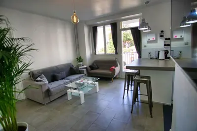 a living room with a couch and a table at Ref SELV -Palmes d'Or Properties in Cannes