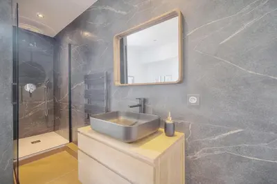 a bathroom with a sink and a mirror and a shower at STANDING - NEUF - Croisette- Palais des festivals - 6 pers -3 chbres in Cannes