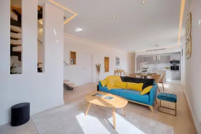 a living room with a blue couch and a table at STANDING - NEUF - Croisette- Palais des festivals - 6 pers -3 chbres in Cannes