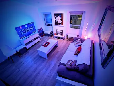 a living room with a couch and a tv at Cannes Croisette Suquet Duplex 4 P in Cannes