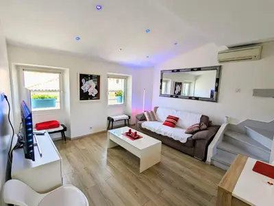 a living room with a couch and a table at Cannes Croisette Suquet Duplex 4 P in Cannes