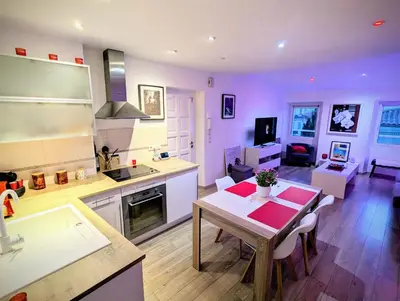 a kitchen and living room with a table and a dining room at Cannes Croisette Suquet Duplex 4 P in Cannes