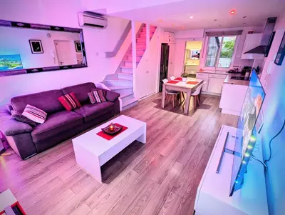 a living room with a couch and a table at Cannes Croisette Suquet Duplex 4 P in Cannes