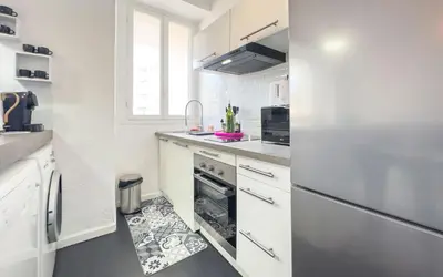 a white kitchen with a sink and a dishwasher at Le Selvosa by Winsome Destination in Cannes