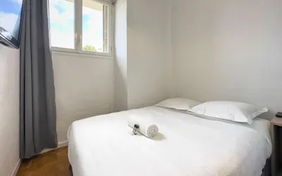 a white bed with a towel on it with a window at Le Selvosa by Winsome Destination in Cannes