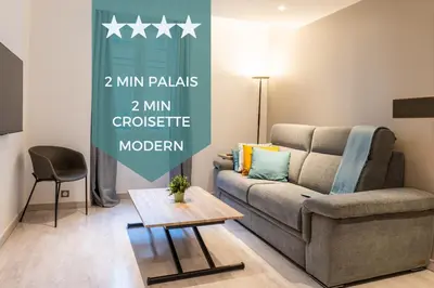 a living room with a couch and a table at 1-Br apartment close to the beaches in Cannes