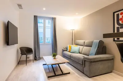 a living room with a couch and a table at 1-Br apartment close to the beaches in Cannes
