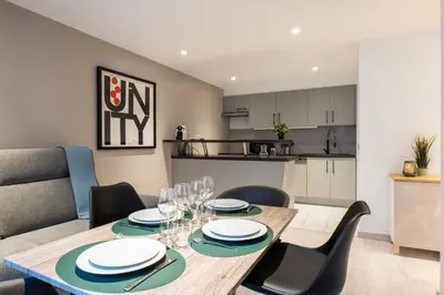 a dining room with a table and chairs and a kitchen at 1-Br apartment close to the beaches in Cannes