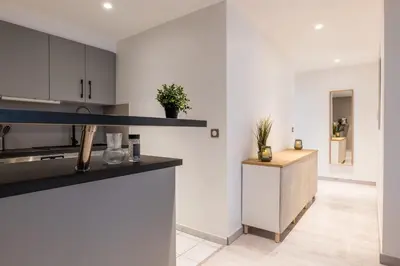 a kitchen with white walls and a counter top at 1-Br apartment close to the beaches in Cannes