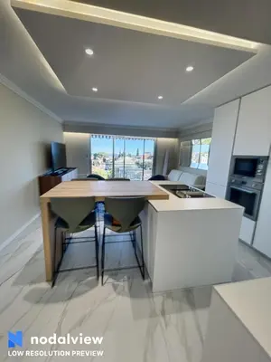 a kitchen with a table and chairs in a room at Cannes Appartement 3 pièces vue mer in Cannes