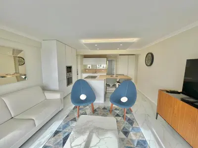 a living room with two blue chairs and a couch at Cannes Appartement 3 pièces vue mer in Cannes