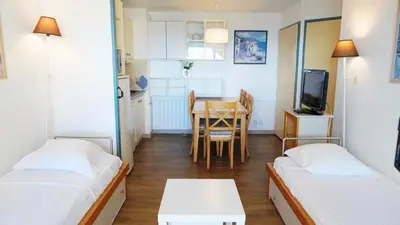 a small room with two beds and a table at Appartement 616, 5 personnes belle vue Mer By Palmazur Vacances in Cannes