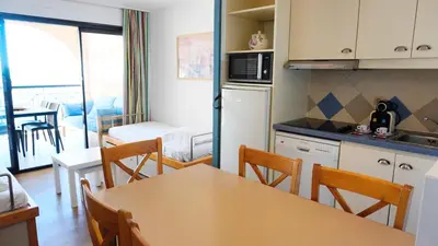 a kitchen and dining room with a table and chairs at Appartement 616, 5 personnes belle vue Mer By Palmazur Vacances in Cannes