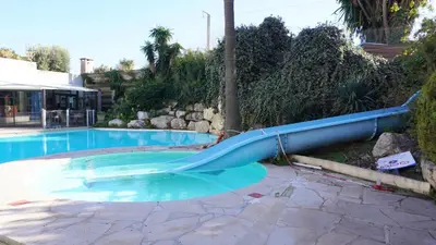 a blue plastic slide in a swimming pool at Appartement 616, 5 personnes belle vue Mer By Palmazur Vacances in Cannes