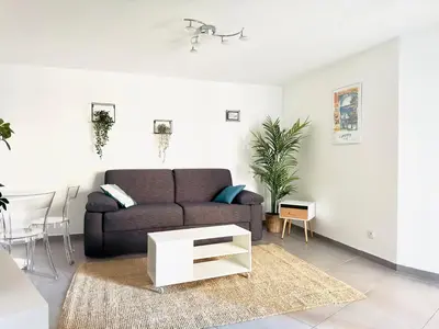 a living room with a couch and a table at Le Cocon - 2 pièces centre Cannes - Terrasse in Cannes