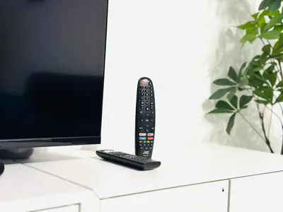 a remote control sitting on top of a desk at Le Cocon - 2 pièces centre Cannes - Terrasse in Cannes