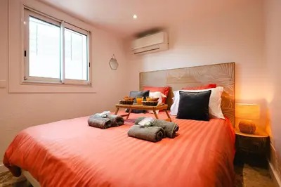 a bedroom with a large bed with three pillows on it at Piscine-Jacuzzi-Sauna -Videoprojecteur Perle Rare in Mougins