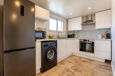 a kitchen with a washer and a dishwasher at Piscine-Jacuzzi-Sauna -Videoprojecteur Perle Rare in Mougins