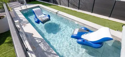 a swimming pool with two inflatable chairs in it at Piscine-Jacuzzi-Sauna -Videoprojecteur Perle Rare in Mougins