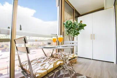 a room with a table and chairs and a large window at Elena YourHostHelper in Cannes