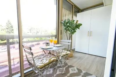 a dining room with a table and chairs and a window at Elena YourHostHelper in Cannes
