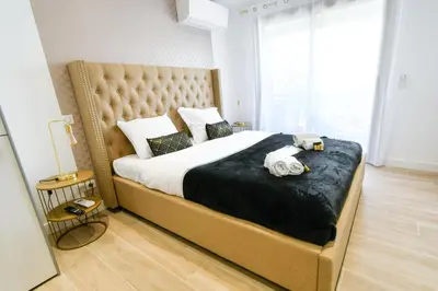 a bedroom with a large bed with towels on it at Elena YourHostHelper in Cannes