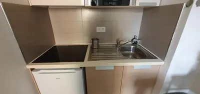 a small kitchen with a sink and a microwave at Joli Duplex cathédrale in Cannes
