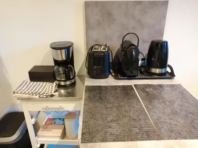 a table with two coffees and a coffee maker on it at Joli Duplex cathédrale in Cannes