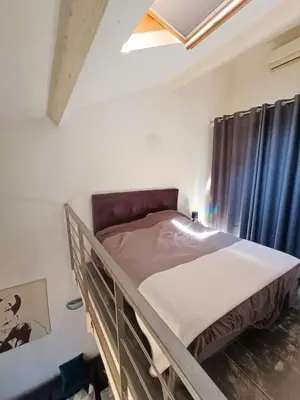 a bunk bed in a room with a window at Joli Duplex cathédrale in Cannes