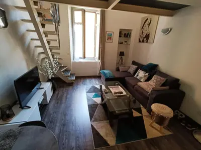 a living room with a couch and a table at Joli Duplex cathédrale in Cannes