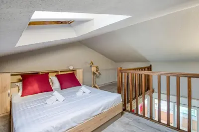 a bedroom with a bed with red pillows on it at Mer et Plage 2 étoiles in Cannes