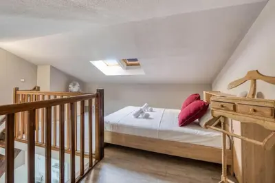 a bedroom with a bed with red pillows on it at Mer et Plage 2 étoiles in Cannes