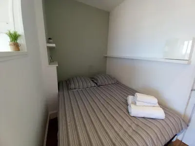 a small room with a bed with towels on it at Chenonceau in Cannes