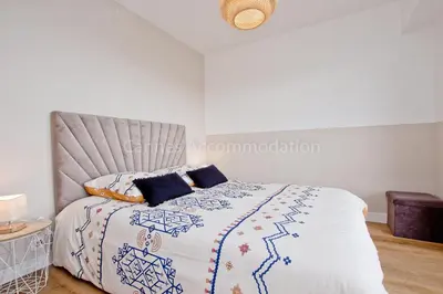 a bedroom with a bed with a blue and white comforter at Tulette in Cannes