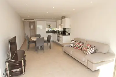 a living room with a couch and a dining room at Johnny in Cannes