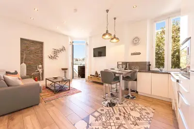 a kitchen and living room with a couch and a table at Downtown Cannes walk to Beaches and Croisette in Cannes