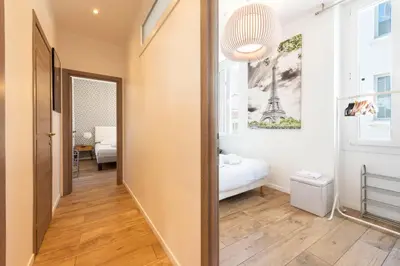 a hallway with a room with a bed and a mirror at Downtown Cannes walk to Beaches and Croisette in Cannes