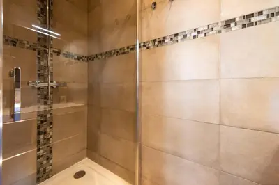 a shower with a glass door in a bathroom at Downtown Cannes walk to Beaches and Croisette in Cannes