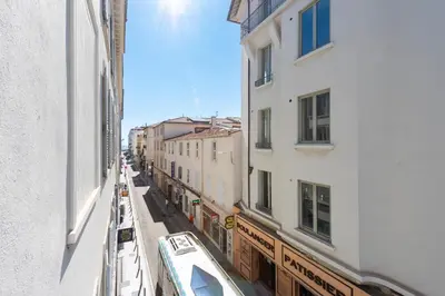 a view of a street between two buildings at Downtown Cannes walk to Beaches and Croisette in Cannes