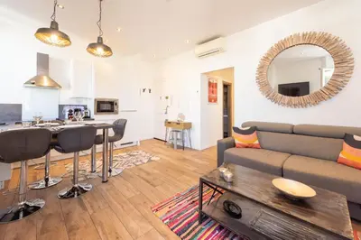 a living room with a couch and a table at Downtown Cannes walk to Beaches and Croisette in Cannes