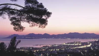 a view of a city and the ocean at sunset at Preyre 14 in Cannes