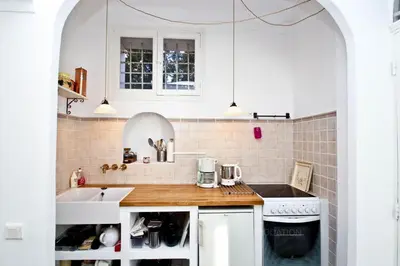 a kitchen with white cabinets and a sink at Preyre 14 in Cannes